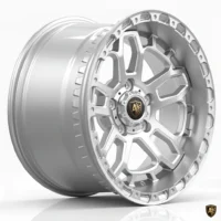 Sleek silver alloy wheel with intricate design and logo, perfect for enhancing vehicle style and performance.