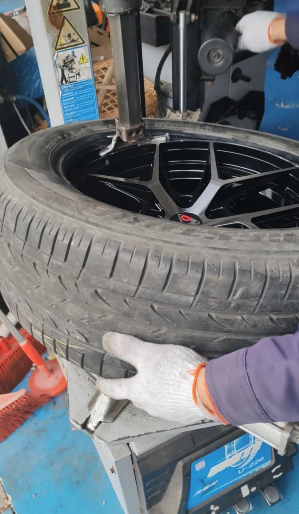 Technician installing tire on AEGIS RIM Gripsafe wheel using standard process