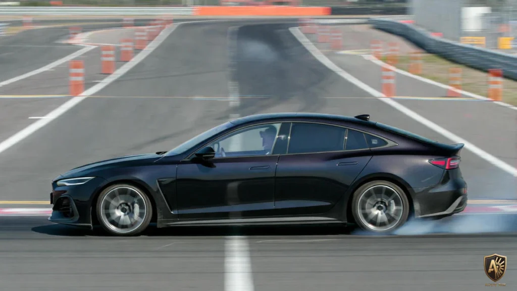 A sleek black sports car drifts on a racetrack, showcasing speed and precision driving skills.