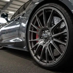 Precision meets velocity. This racetrack hero shot captures the essence of AEGIS forged wheels—engineered for micron-level balance, zero vibration, and razor-sharp handling. When every apex demands trust, CNC perfection delivers High-performance sports car equipped with forged wheels on a racetrack, captured in dynamic motion to highlight speed, control, and precision engineering.