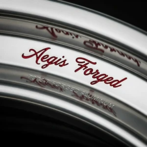 Details that speak — Even the lip engraving is customized to reflect each client’s vision. At AEGIS RIM, no detail is too small to perfect. Custom red script engraving on AEGIS RIM lip, tailored to client specification.