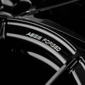AEGIS RIM forged wheel lip—precision engraving delivers lasting identity, craftsmanship, and visual distinction. Lip engraving on AEGIS RIM forged alloy wheel—illustrating precision marking for brand identity and surface personalization.