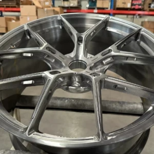 One by one, nothing overlooked — Every AEGIS RIM wheel is manually inspected to uphold our uncompromising standards of finish and structural integrity. AEGIS RIM technician manually inspecting each forged wheel on the pallet, ensuring surface integrity and production consistency.