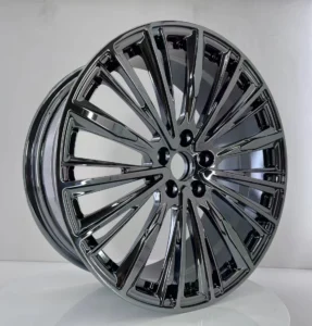 Glossy black alloy wheel showcasing a stylish, modern design with intricate spokes and sleek finish against a light backdrop.