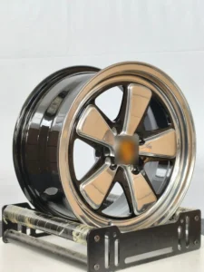 Close-up of a sleek chrome alloy wheel displaying a modern design and polished finish on a black background.