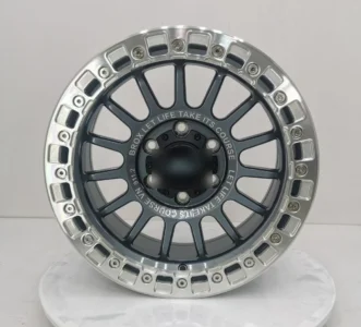Stylish alloy wheel with silver and dark gray finish, featuring unique design and engraved text for a custom look.