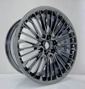 Sleek black alloy wheel showcasing a modern design with vibrant reflections, perfect for customizing vehicles.